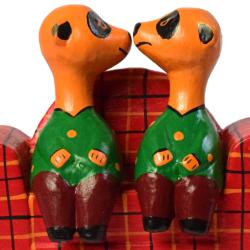 2 Meerkats on a tartan sofa hand carved from Albesia wood